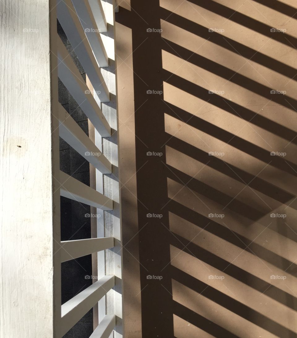 Top view of y balcony rail . Sunlight filtering through the rails in my balcony.  Top view. 