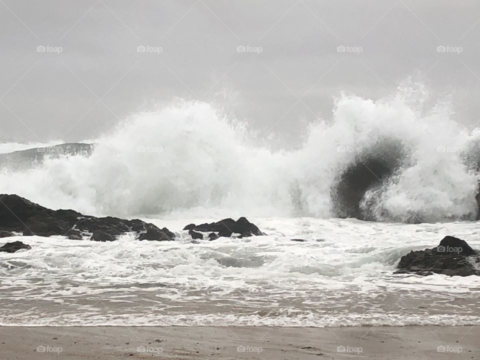 A stormy wave, crashed against rocks on the beach - no edits, #nofilter #truenature #truephotos