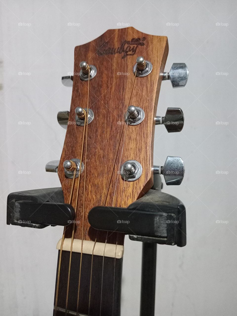 An acoustic guitar is a type of guitar where the sound produced comes from the vibration of the guitar strings that are channeled through the saddle and bridge where the strings are attached into the sound chamber