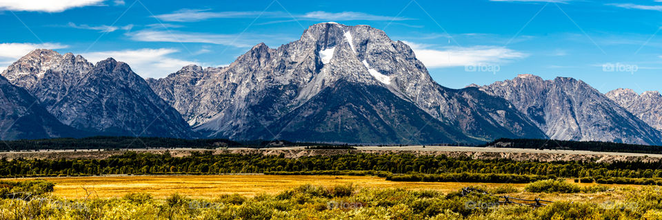 The majestic Grand Tetons holding their last bit of snow in the late summer light. 