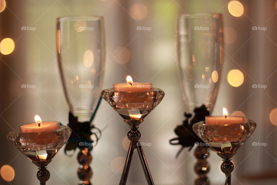 Two champagne flutes with glittering candles