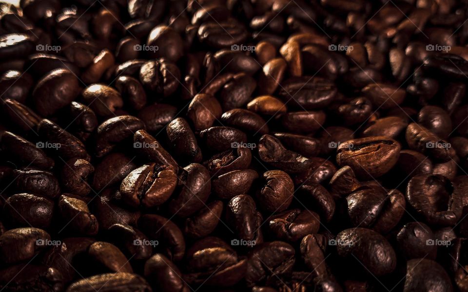 Aromatic roasted coffee beans close-up. Macro, soft selective focus.