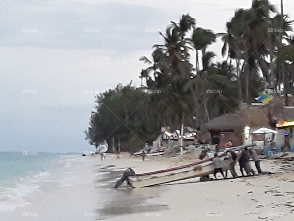 the beach people pull the boat ashore