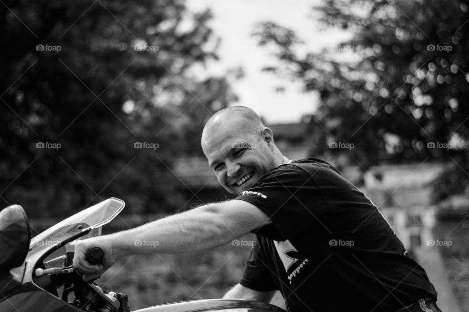 motorcyclist smiling on his bike