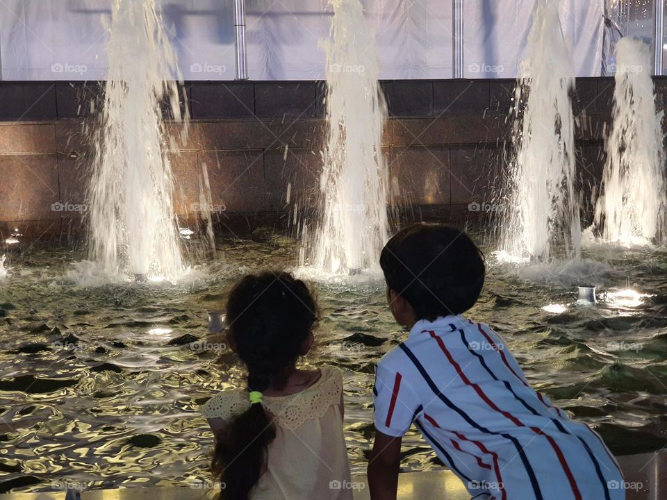 kids watching water fountain