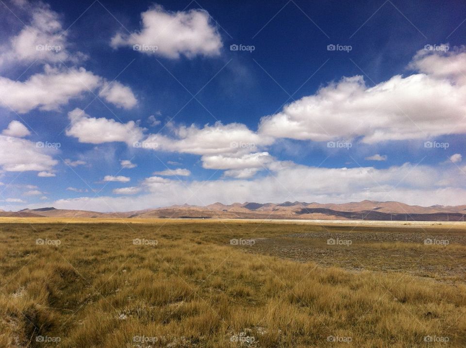 beautiful Tibetan landscape with cloudy sky and mountain peaks