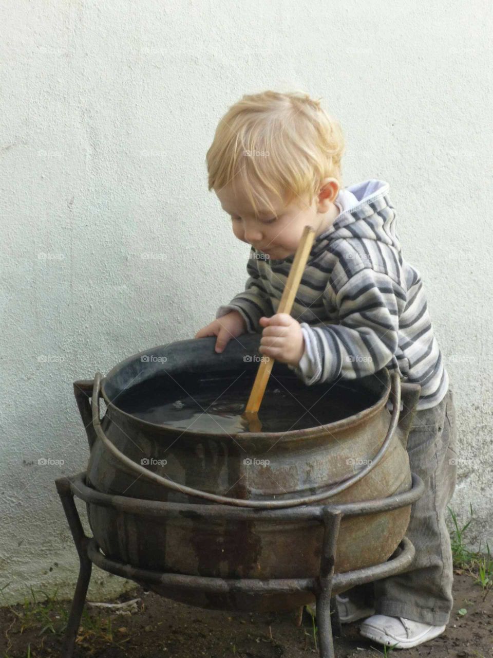 child stirring pot. Child playing