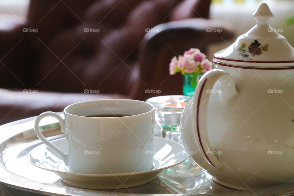 Close-up of tea cup and teapot
