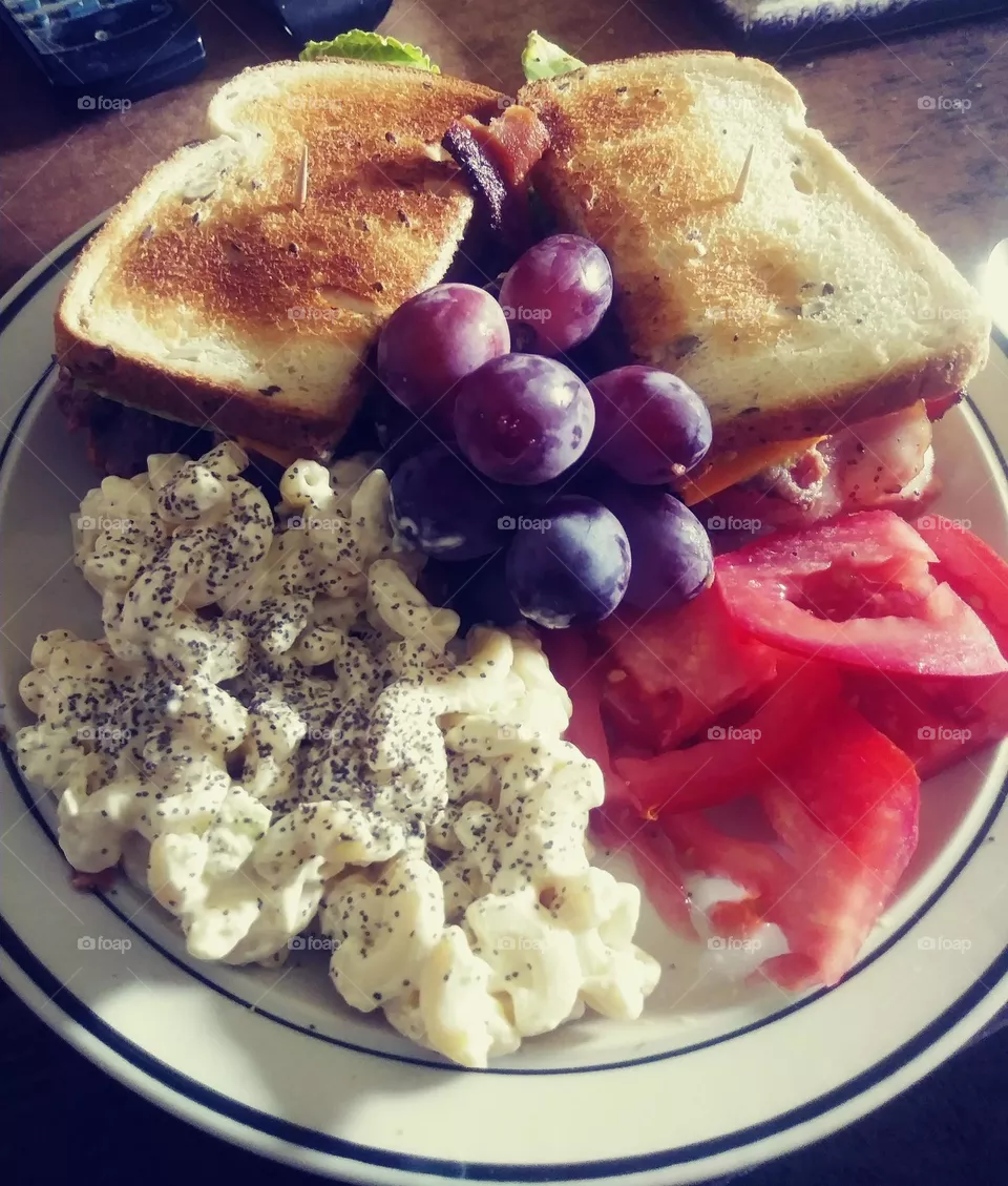 epic sandwich night. turkey BLT and macaroni salad, grapes and salt and peppered tomatoes