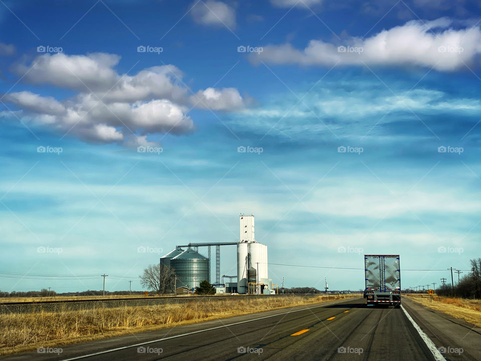 Nebraska highway with a grain silo by the side of the road