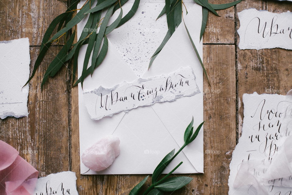 Graphic arts of beautiful wedding calligraphy cards with flower and mineral stone on wood background