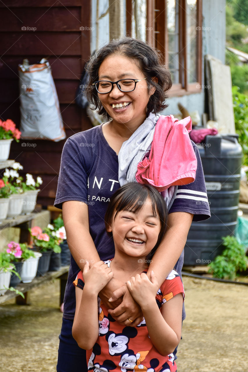 A woman and her child sharing a beautiful moment of joy and happiness.