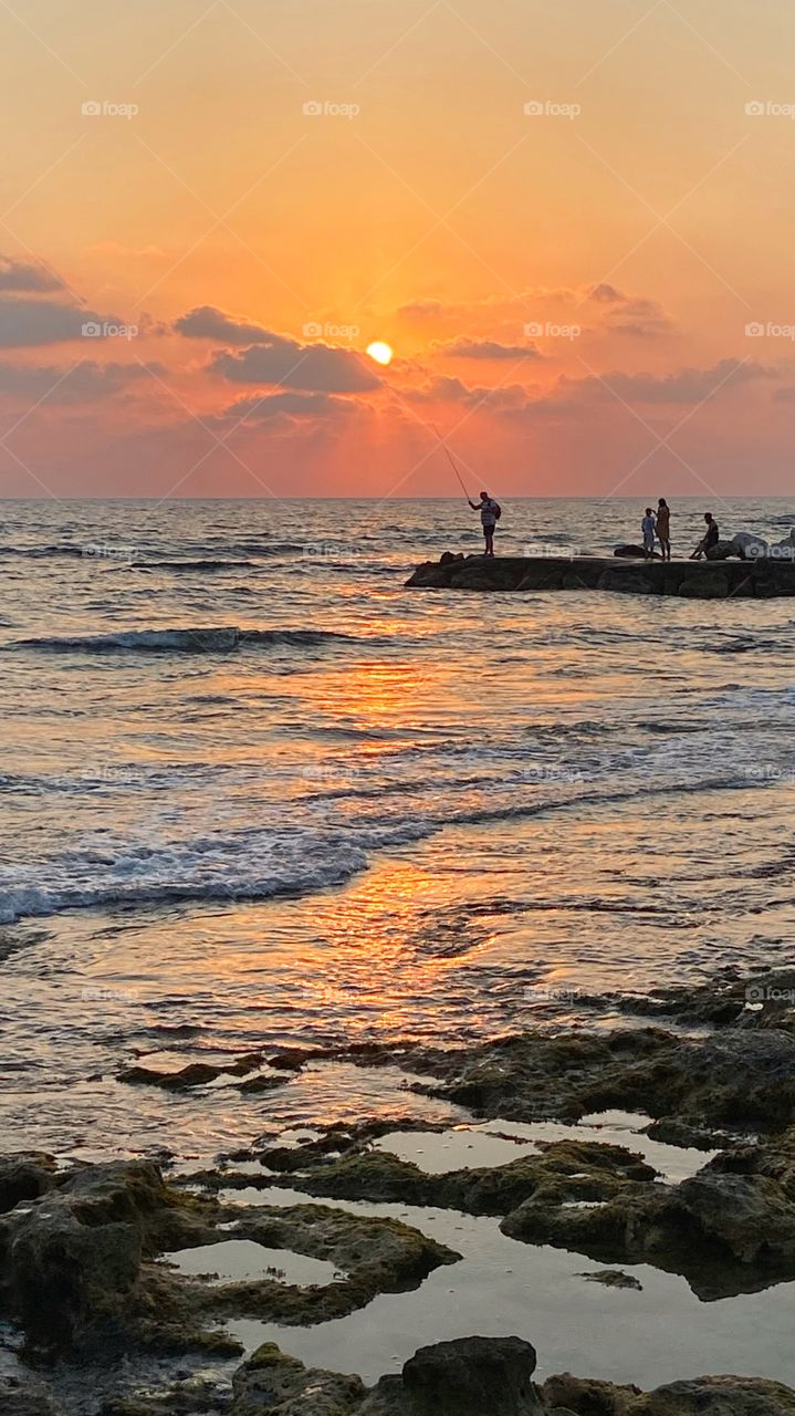 Fishing at sunset time, in Paphos, Cyprus. 