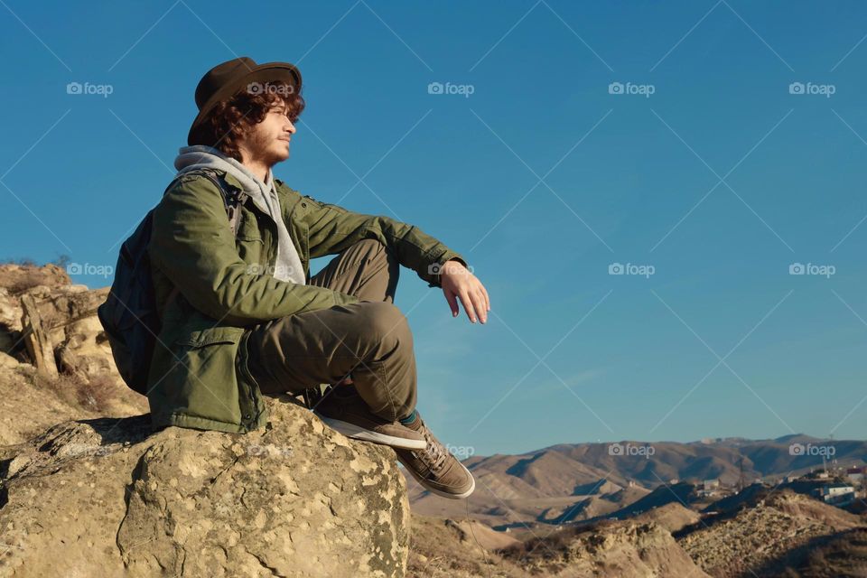 Man sitting on a cliff 