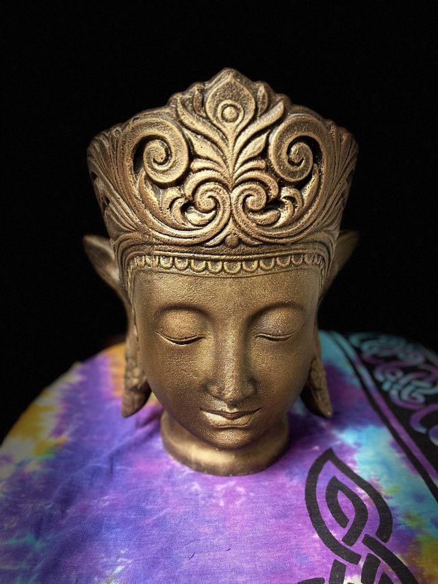 A Golden Buddha Meditating in the dark.