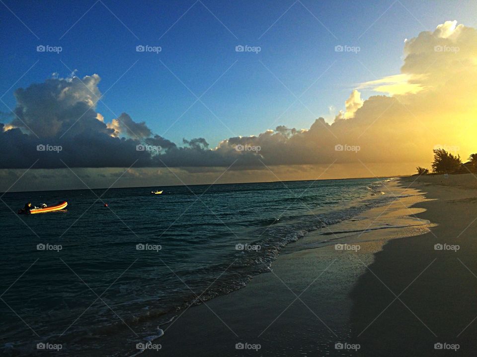 Ocean at Sunset. A boat on the ocean at sunset