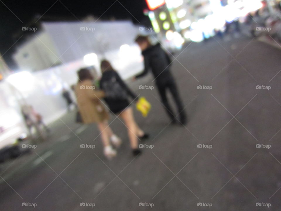 Kabukicho, Shinjuku, Tokyo, Japan. Red Light District Host Giving Flyer to Two Fashionable Girls on the Street.