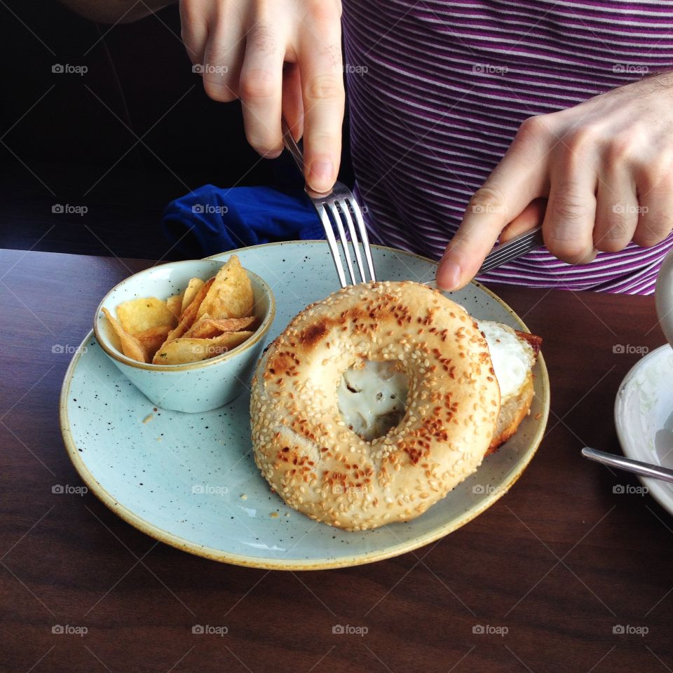 Person eating a bagel