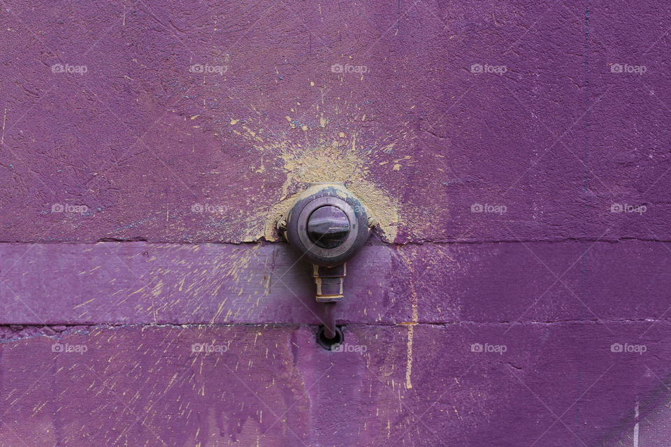 light switch on a purple wall