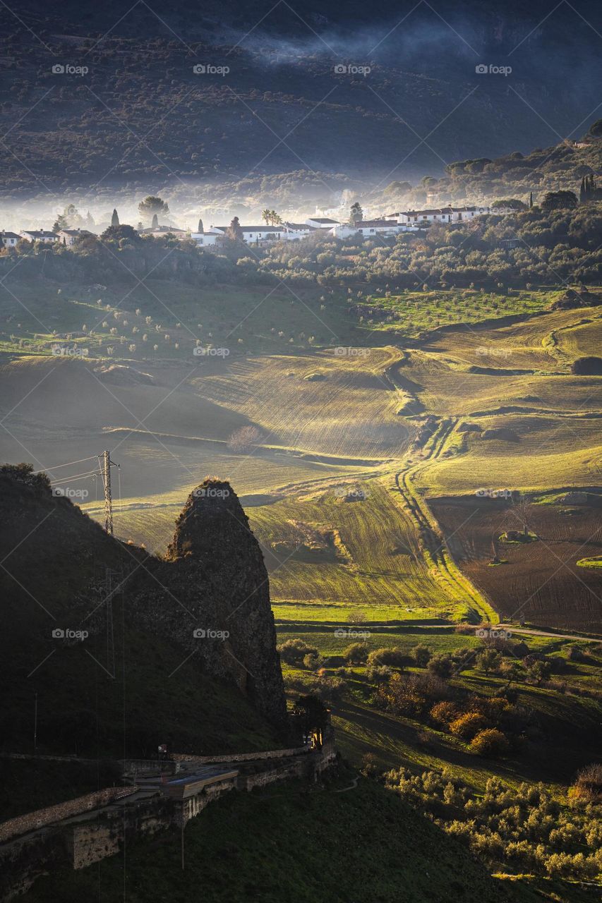 Valley of Ronda village in Andalucía, Spain! Green agriculture land, morning fog.