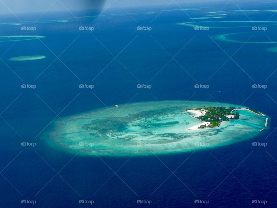 Aerial view of blue sea around Maldives islands