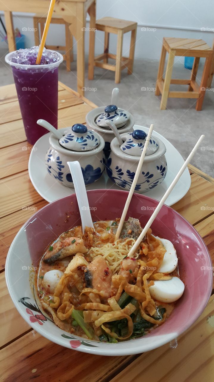 Street food noodles. ready to eat delicious Thai spicy curry noodle soup