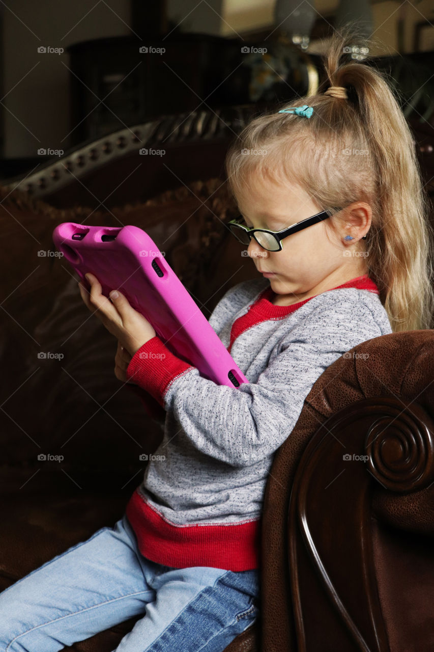 Girl playing on a tablet