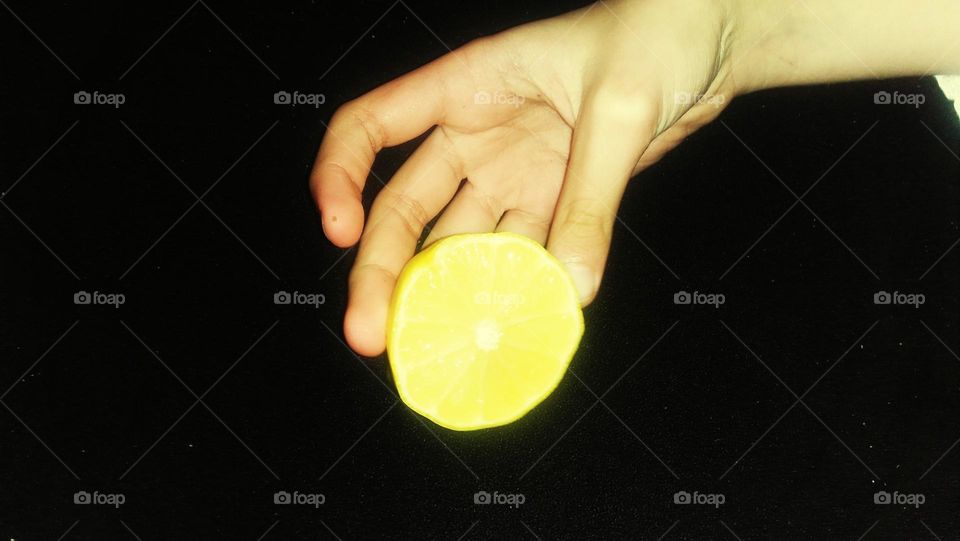 Little Hand holds lemon.