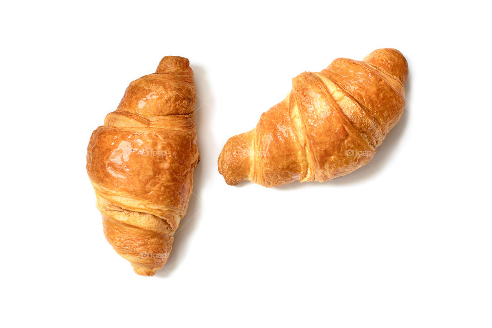 Two plain croissants isolated on white