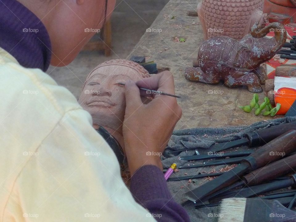 Close-up Of artist sculpting at workshop