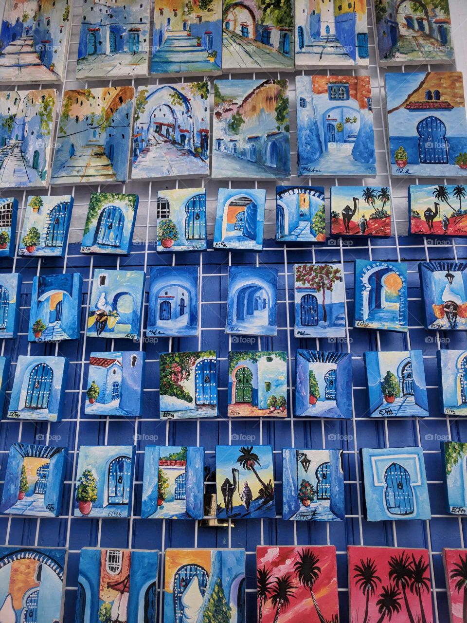 Artwork/Paintings of the Blue Buildings, Homes, Arches, and Doors of Chefchaouen by Local Artists (Street Market of Chefchaouen, the Blue City, in Morocco)