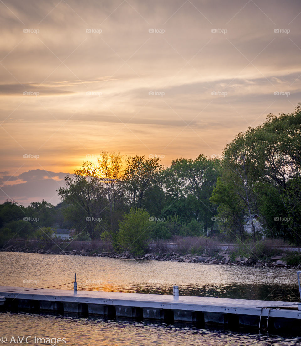 Sunset on the lake in Wisconsin. Empty pier at sunset in Wisconsin Pewaukee Lake