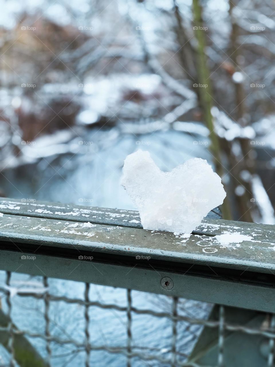 Heart shaped ice on rustic bridge 