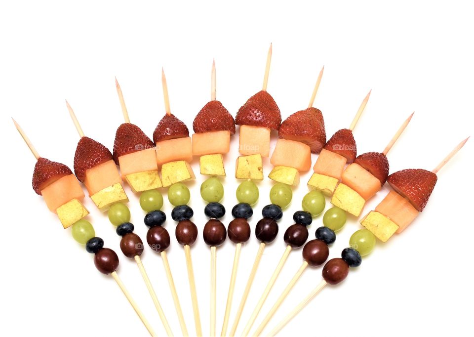 Rainbow of fruit on skewers 