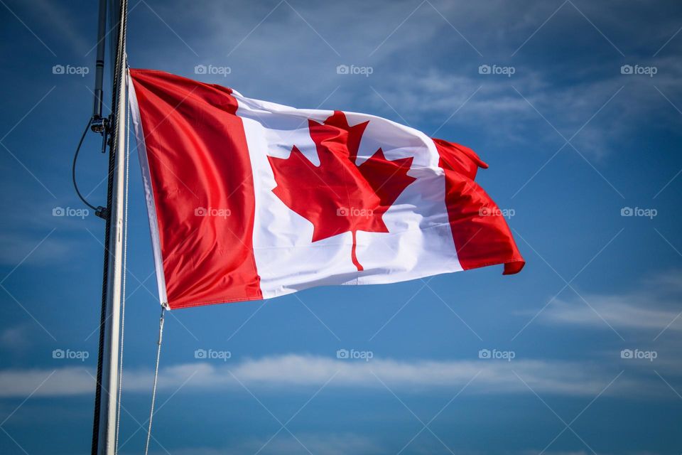 Canadian flag with a blue sky background