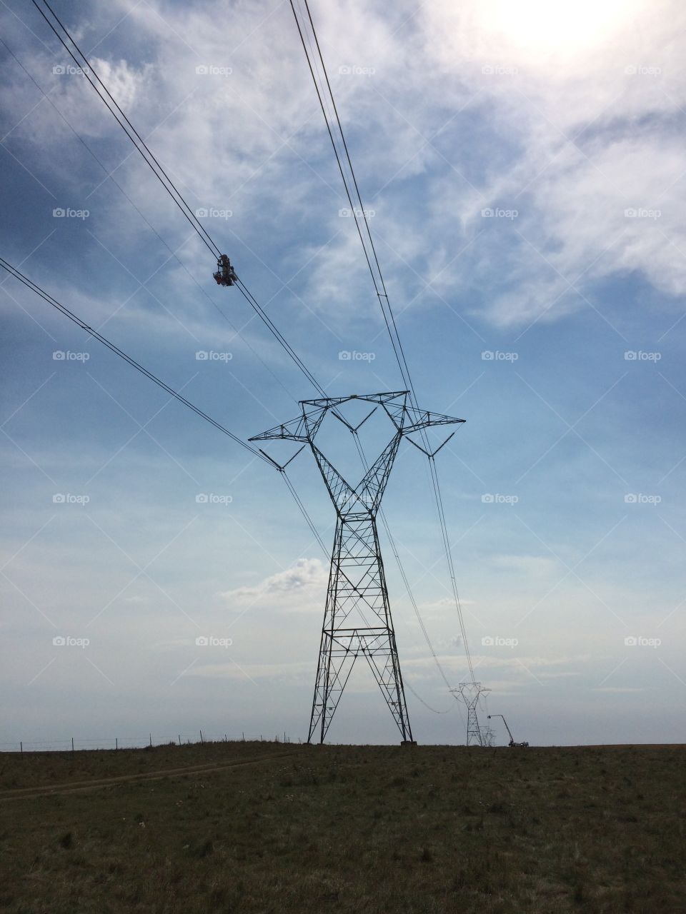Lineman working on wire energized 345,000 volt line in a hot suit. 
