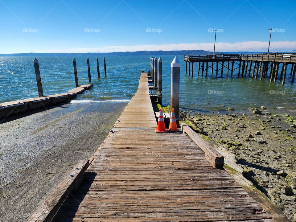 A walkway near a boat ramp juts into Puget Sound near Seattle Washington