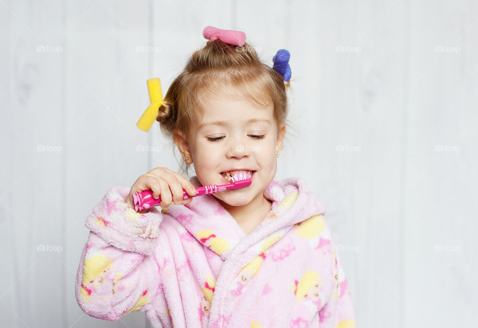 little girl brushing teeth