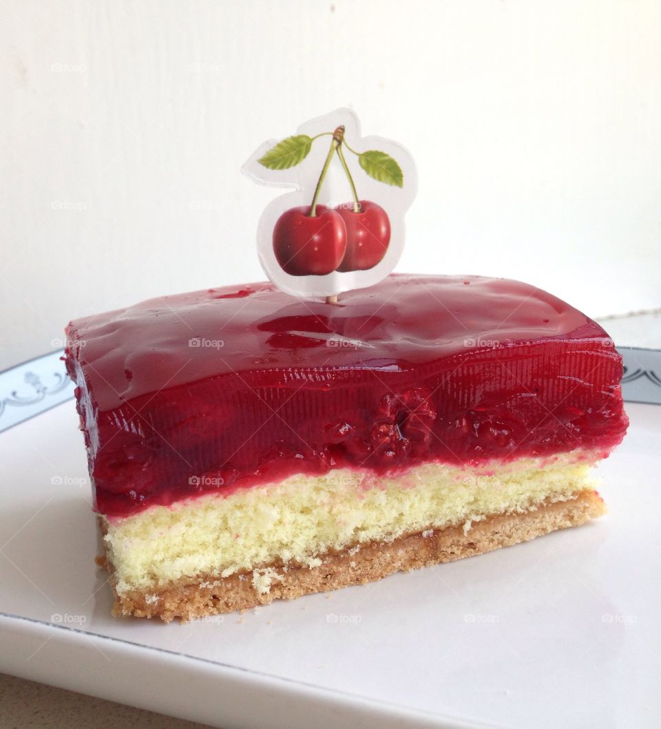 Delicious Cherry Cake. Red jelly and Rasberry and Cherry cake slice