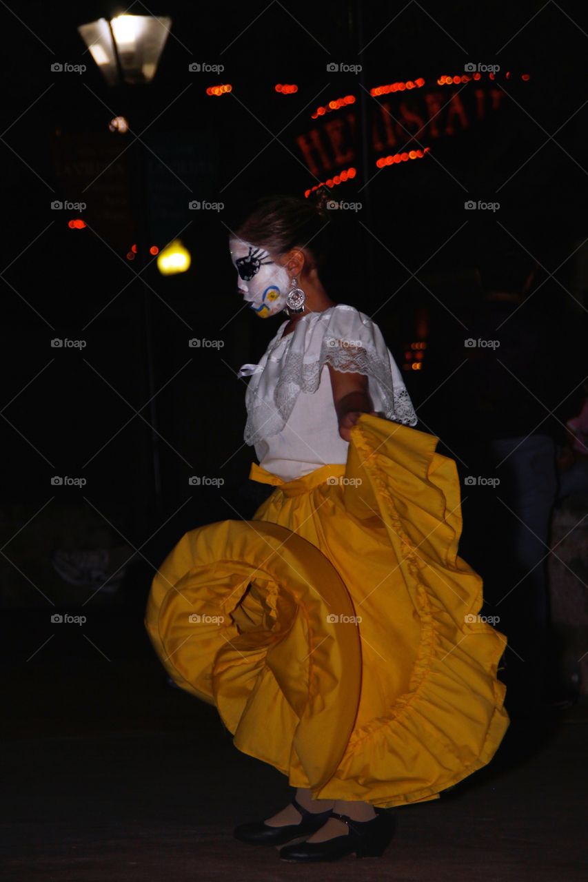 A young girl dances in costume at the San Antonio Día de los Muertos festival. 