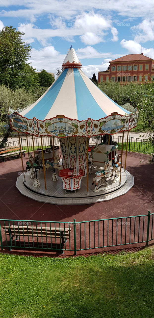 Tradional French carrousel with the Matisse museum in the background in Nice, France