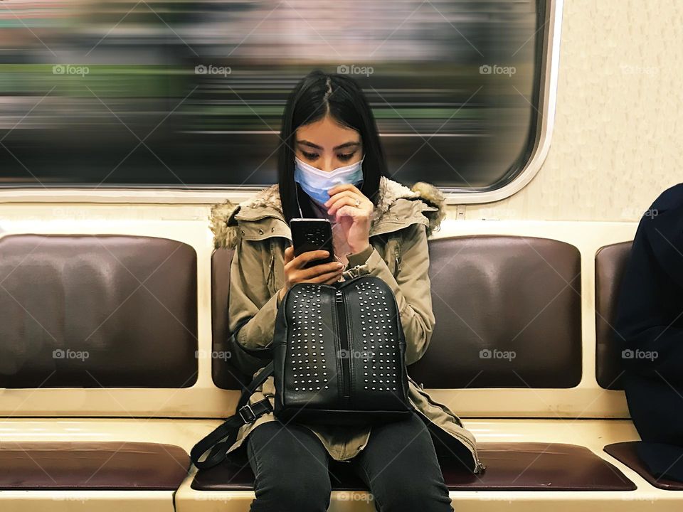 Using mobile phone at subway train 