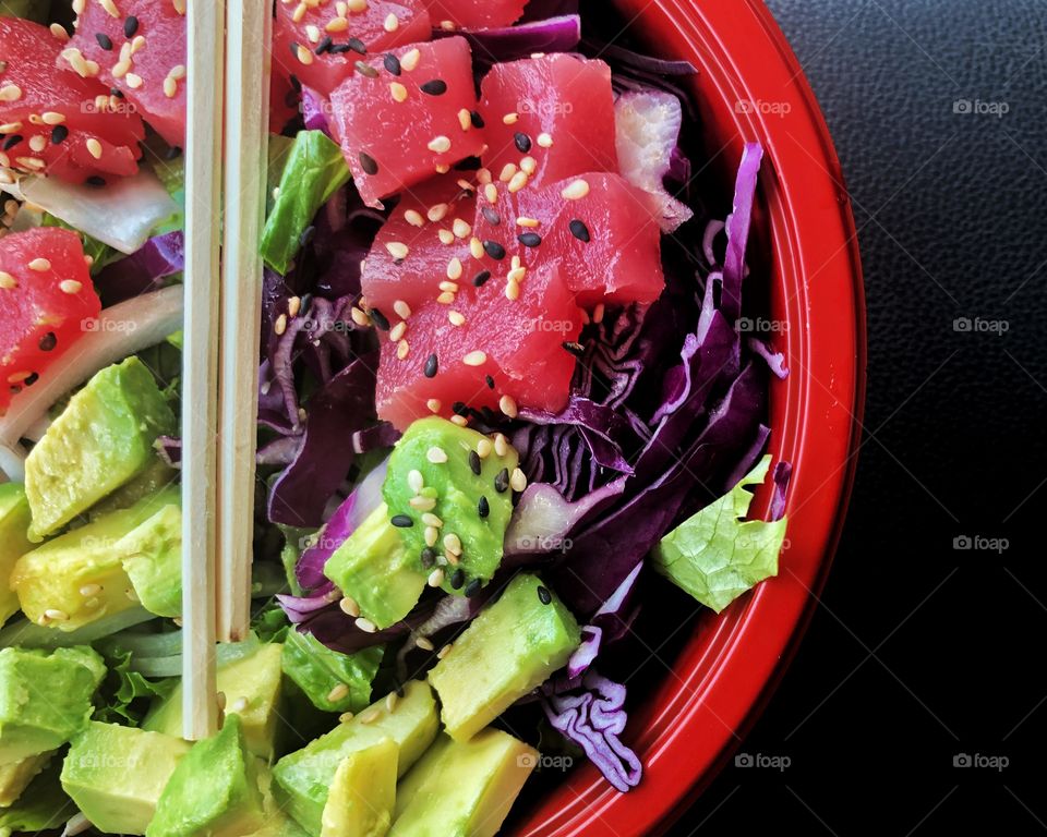 Close up of red tuna and rice in red bowl 