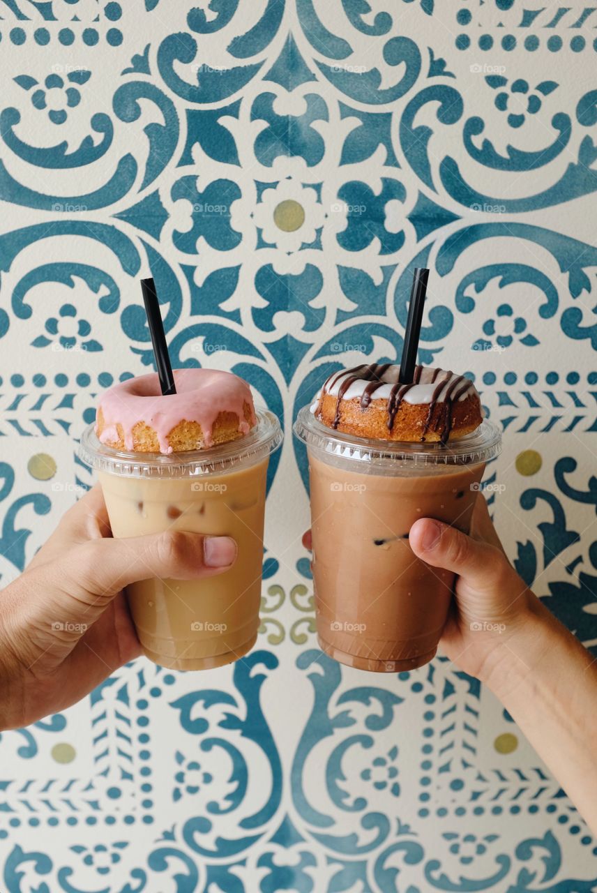 Close-up of iced coffee with donut