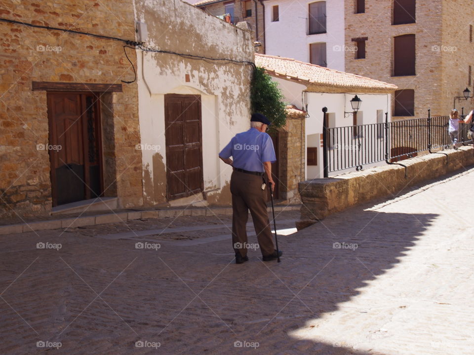 Man walking on stone village in Teruel Spain