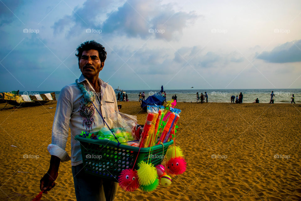 Seller selling toys at beach