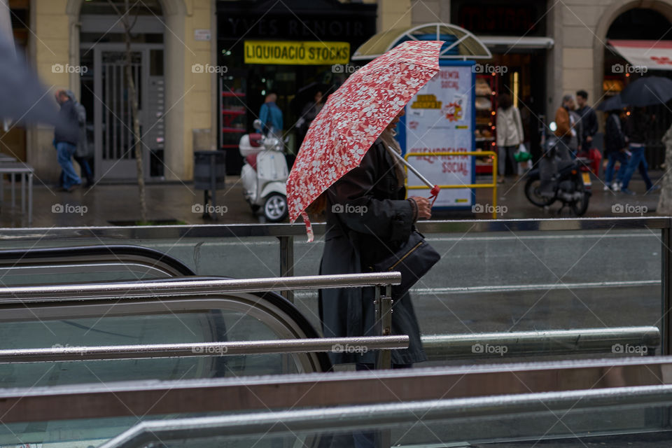 Out of the metro in a rainy day