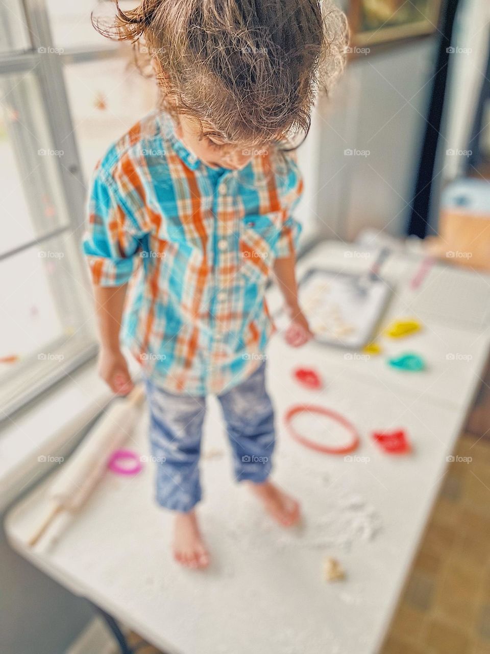Toddler all dirty after baking with Mommy, toddler making a mess, toddler looks at mess made, Easter traditional cookies, making sugar cookies with Mommy, family time at home with Mommy, toddler loves baking with Mommy