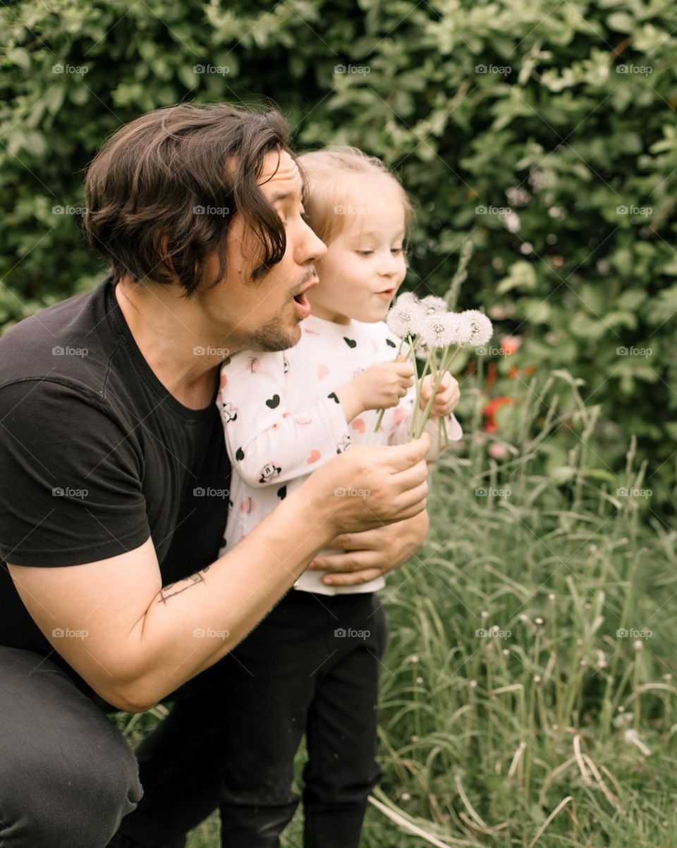 Having fun with dandelions.