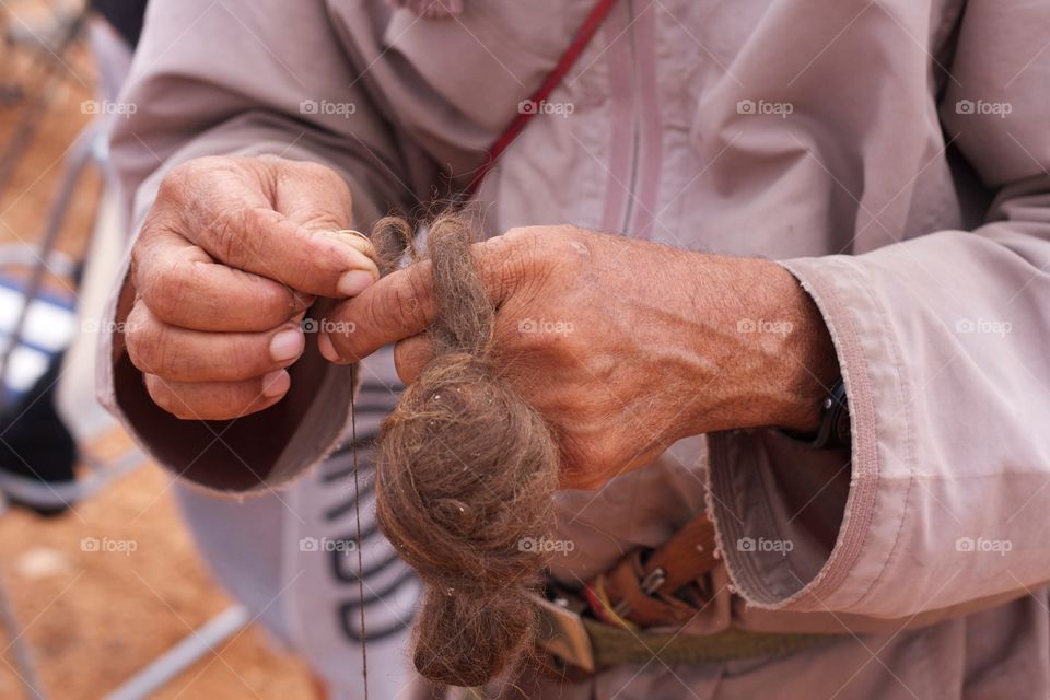 Close-up of a person spinning yarn